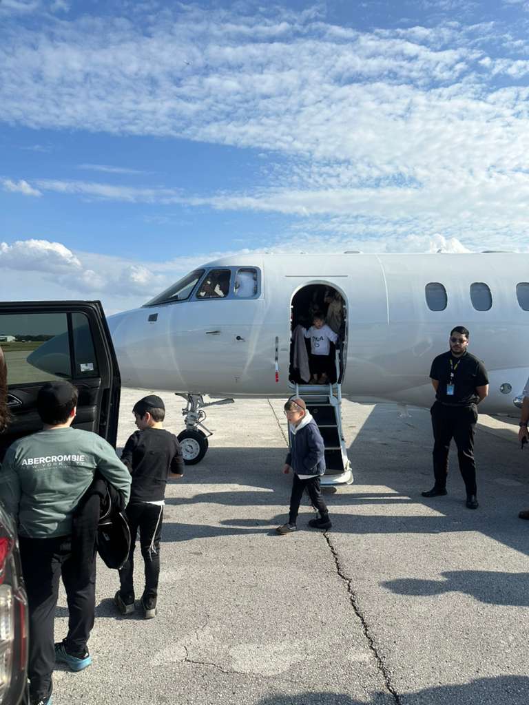 Passengers arriving from a private jet for chauffeur pickup