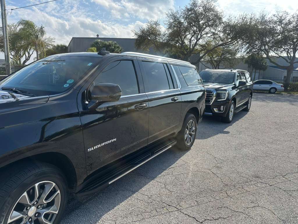 Black executive SUVs lined up for premium transportation service